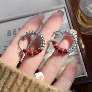 Unique caterpillar hoop earrings featuring red enamel and zircon stones in silver finish