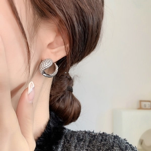 Silver foxtail stud earrings with cubic zirconia pavé setting worn by a model