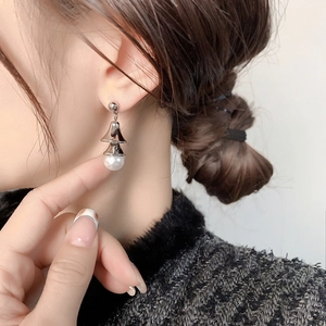 Elegant Chinese style pearl bell drop earrings with gold plating on an Asian female model