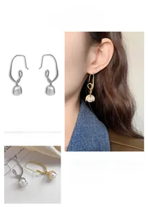 Close-up of pearl knot drop earrings in 24K gold and silver plating detail