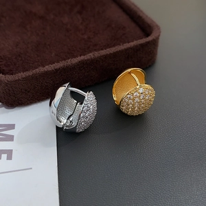 Luxurious gold and silver chunky hoop earrings set with pavé cubic zirconia crystals
