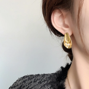 Elegant 24K gold plated double leaf pearl stud earrings on model in 45-degree side view