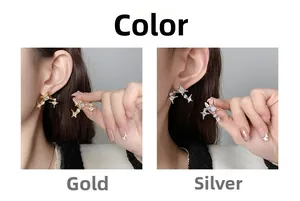 Detail view of gold and silver four-pointed star earrings with sparkling cubic zirconia