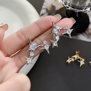 Detail of silver starburst earrings featuring pavé cubic zirconia in a long star shape