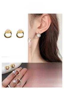 Detail of round pearl hoop earrings with elegant gold and silver metal finishes