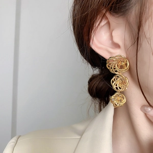 Elegant 18K gold-plated layered hollow circle earrings worn by model for a luxury look