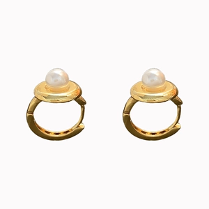 Elegant gold hoop earrings featuring a polished white pearl setting on a white background