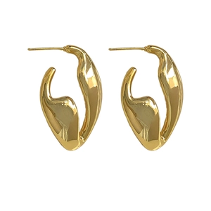 Minimalist irregular geometric gold earrings with a polished lava-style fluid design