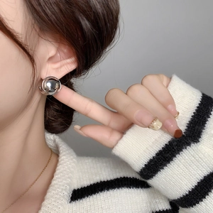 Minimalist polished silver spherical stud earrings with a glossy metallic finish