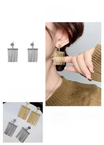 Long gold tassel earrings for women featuring sleek linear strands in a minimalist design