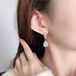 Elegant silver pear-cut zircon teardrop earring with tassel accent on model