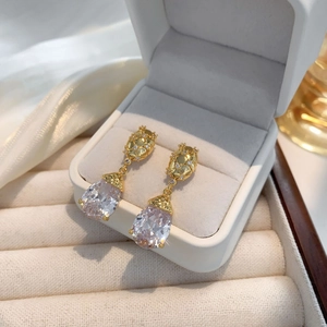 Elegant gold drop earrings with large pear-cut cubic zirconia in a white velvet box