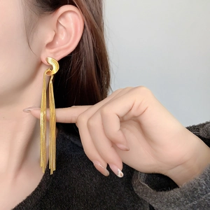 Vintage 18K gold-plated brass chain tassel earrings on model showing elegant drape
