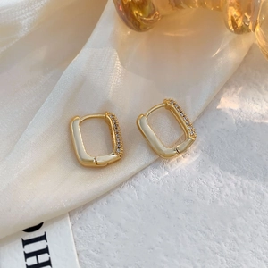 Elegant gold plated rectangular hoop earrings with cubic zirconia on white silk
