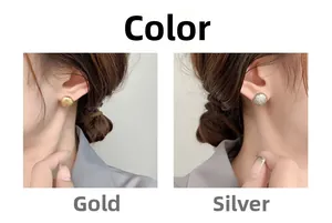 Detail view of round textured button earrings in gold and silver finishes