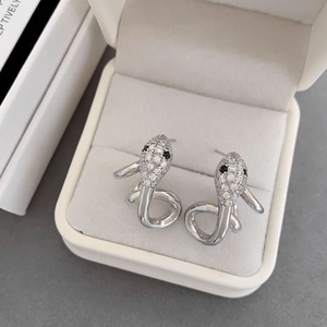 Sparkling silver snake stud earrings with white cubic zirconia in a white jewelry box