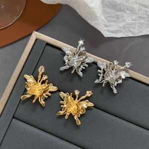 Elegant butterfly stud earrings in gold and silver finish with zircon stones on gray box