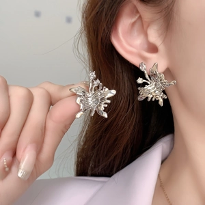 Elegant liquid metal silver butterfly stud earrings with sparkling zircons worn by model