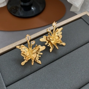 Detailed view of elegant gold butterfly stud earrings with sparkling cubic zirconia accents