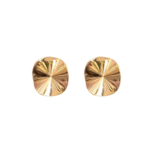 Minimalist gold plated copper stud earrings with irregular sunburst texture on white background