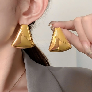 Modern gold-plated chunky triangle hoop earrings with a high-polished metallic finish