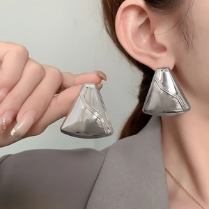 Modern geometric triangle earrings in polished silver finish worn by female model