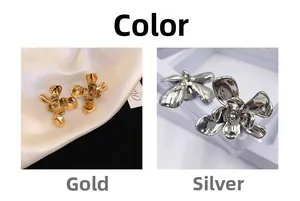 Detailed view of 3D five-petal flower stud earrings in polished gold and silver finishes