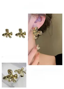 Macro shot of gold-plated flower studs with liquid metal texture and S925 hallmark