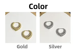 Detailed comparison of gold and silver textured hoop earrings with radial patterns