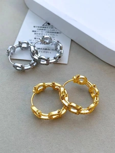 Detailed view of gold and silver plated chain-link hoop earrings with bead accents