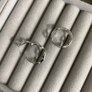 Elegant twisted silver hoop earrings with a textured rope design for a modern minimalist look