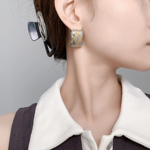 Minimalist square quilted stud earrings in gold and silver finish on model