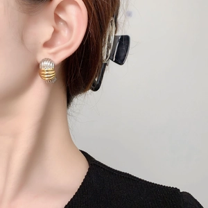 Modern two-tone striped C-shaped stud earrings in gold and silver finish for women