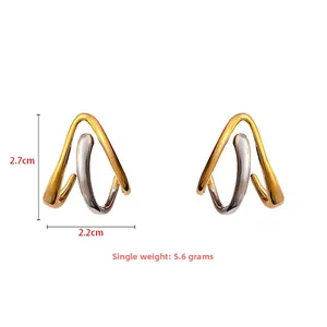 Detail view of geometric two-tone stud earrings with measurements 2.7cm x 2.2cm and 5.6g weight