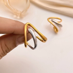 Minimalist geometric two-tone gold and silver earrings with polished crossed U-shape lines