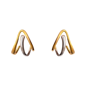 Macro shot of geometric two-tone gold and silver earrings with triangular twisted design