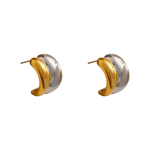 Minimalist C-shaped two-tone gold and silver earrings with polished mirror finish