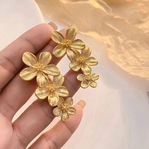 Boucles d'oreilles fleurs triple dorées 18K avec une élégante texture en métal brossé