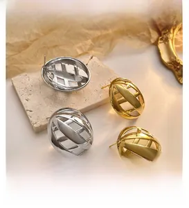 Detailed view of hollow mesh oval stud earrings in gold and silver finish