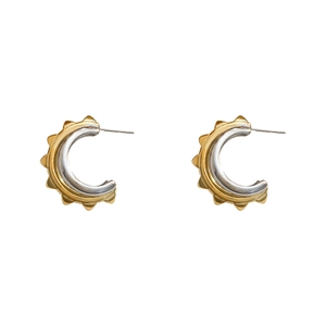 Modern C-shaped gold and silver earrings with textured sunburst pattern finish