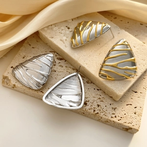Textured irregular triangle stud earrings in gold and silver plating on stone base