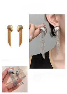 Detail view of long tassel earrings with metallic chain fringe in gold and silver finish