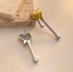 Melting gold and silver heart stud earrings in polished liquid metal style