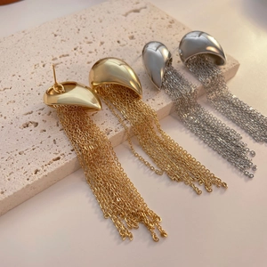 Modern gold and silver teardrop earrings with long metallic tassel chains set