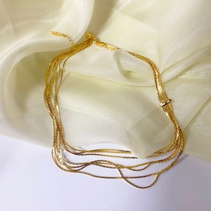 Chic multi-layered gold snake chain necklace with adjustable lobster clasp on silk