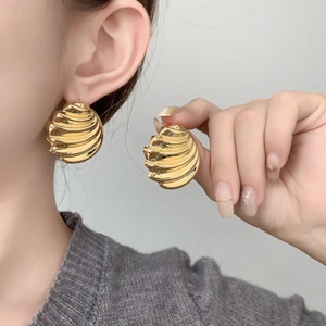 Golden ribbed dome earrings with shell texture in a minimalist metal design