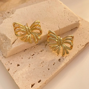 Elegant gold-plated ribbon bow stud earrings with sparkling zircon accents on stone