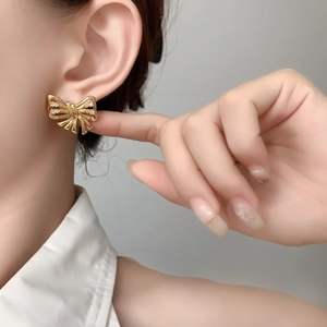 Elegant gold butterfly stud earrings with sparkling zircon inlay and textured finish
