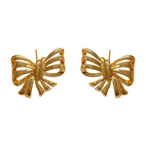 Polished gold-plated ribbon bow stud earrings for women on a clean white background