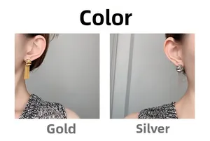 Detail view of gold and silver chain tassel earrings showing elegant draped movement